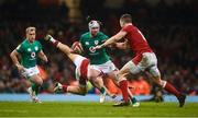 4 February 2023; Mack Hansen of Ireland is tackled by George North, right, and Joe Hawkins of Wales during the Guinness Six Nations Rugby Championship match between Wales and Ireland at Principality Stadium in Cardiff, Wales. Photo by David Fitzgerald/Sportsfile