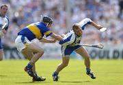 6 June 2004; Eoin McGrath, Waterford, holds possession despite being tackled by Thomas Costello, Tipperary. Guinness Munster Senior Hurling Championship semi-final, Tipperary v Waterford, Pairc Ui Chaoimh, Cork. Picture credit; Brendan Moran / SPORTSFILE
