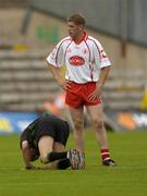 6 June 2004; Referee Seamus McCormack takes a fall as Tyrone's Kevin Hughes looks on. Bank of Ireland Ulster Senior Football Championship, Tyrone v Fermanagh, St. Tighernach's Park, Clones, Co. Monaghan. Picture credit; Damien Eagers / SPORTSFILE