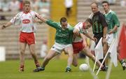 6 June 2004; Ciaran Gourley, Tyrone, in action against Niall Bogue, Fermanagh, as Tyrone's Kevin Hughes and linesman Martin Brady look on. Bank of Ireland Ulster Senior Football Championship, Tyrone v Fermanagh, St. Tighernach's Park, Clones, Co. Monaghan. Picture credit; Damien Eagers / SPORTSFILE