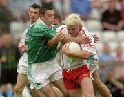 6 June 2004; Owen Mulligan, Tyrone, is tackled by Damian Kelly, Fermanagh. Bank of Ireland Ulster Senior Football Championship, Tyrone v Fermanagh, St. Tighernach's Park, Clones, Co. Monaghan. Picture credit; Damien Eagers / SPORTSFILE