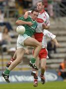 6 June 2004; Gavin Devlin,Tyrone, contests a high ball with Fermanagh's James Sherry. Bank of Ireland Ulster Senior Football Championship, Tyrone v Fermanagh, St. Tighernach's Park, Clones, Co. Monaghan. Picture credit; Damien Eagers / SPORTSFILE