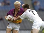 6 June 2004; Redmond Barry, Wexford, is tackled by Karl Ennis, Kildare. Bank of Ireland Leinster Senior Football Championship, Wexford v Kildare, Croke Park, Dublin. Picture credit; David Maher / SPORTSFILE
