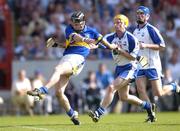 6 June 2004; Colin Morrissey, Tipperary, kicks his sides third goal despite the attentions of Waterford's Eoin Murphy and Declan Prendergast, right. Guinness Munster Senior Hurling Championship semi-final, Tipperary v Waterford, Pairc Ui Chaoimh, Cork. Picture credit; Brendan Moran / SPORTSFILE