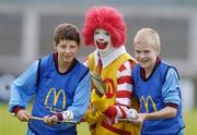 9 June 2004; Ronald McDonald with Pol O Dubhain, 12 years, and Fergal Breathnach, 13, right, from Scoil Mobhi, Glasnevin, Dublin, winners of the Dublin final of the McDonalds Lift & Strike Competition. Parnell Park, Dublin. Picture credit; Ray McManus / SPORTSFILE