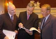 10 June 2004; Denis Egan, left, Chief Executive, The Turf Club, Pierce G Molony, centre, Senior Steward, The Turf Club, and Ivo O'Sullivan, Chairman, Safety Review Group, view the report at the announcement of the Safety Review Group Report and Recommendations published by The Turf Club. The Westbury Hotel, Dublin. Picture credit; Brian Lawless / SPORTSFILE