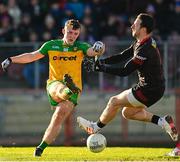 5 February 2023; Jeaic McKelvey of Donegal shoots at goal despite the efforts of Tyrone goalkeeper Niall Morgan during the Allianz Football League Division 1 match between Tyrone and Donegal at O'Neill's Healy Park in Omagh, Tyrone. Photo by Ramsey Cardy/Sportsfile