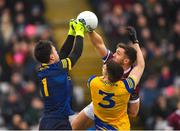 5 February 2023; Roscommon goalkeeper Conor Carroll punches a ball away despite the challenge from Damien Comer of Galway as Conor Daly of Roscommon watches on  during the Allianz Football League Division 1 match between Galway and Roscommon at Pearse Stadium in Galway. Photo by Ray Ryan/Sportsfile