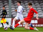 5 February 2023; Adam Lavelle of Galway District League is tackled by Ben Heinen of Cork Youth League during the FAI Youth Inter-League Cup Final 2023 match between Galway District League and Cork Youth League at Eamonn Deacy Park in Galway. Photo by Tyler Miller/Sportsfile
