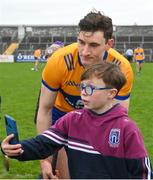 5 February 2023; David Fitzgerald of Clare poses for a 'selfie' with Clare supporter Adam fallon after after the Allianz Hurling League Division 1 Group A match between Clare and Westmeath at Cusack Park in Ennis, Clare. Photo by Ray McManus/Sportsfile