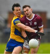 5 February 2023; Tadhg O’Rourke of Roscommon fits the ball away from Cillian McDaid of Galway during the Allianz Football League Division 1 match between Galway and Roscommon at Pearse Stadium in Galway. Photo by Ray Ryan/Sportsfile