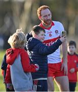 5 February 2023; Conor Glass of Derry with young fans after the Allianz Football League Division 2 match between Louth and Derry at DEFY Pairc Mhuire in Ardee, Louth. Photo by Stephen Marken/Sportsfile