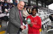 5 February 2023; Harvey Skeiters of Cork Youth League is presented with the Man of the Match award by FAI President Gerry McAnaney after the FAI Youth Inter-League Cup Final 2023 match between Galway District League and Cork Youth League at Eamonn Deacy Park in Galway. Photo by Tyler Miller/Sportsfile