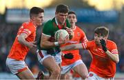 5 February 2023; Jordan Flynn of Mayo is tackled by Jarly Og Burns and Andrew Murnin of Armagh during the Allianz Football League Division 1 match between Armagh and Mayo at Box-It Athletic Grounds in Armagh. Photo by Brendan Moran/Sportsfile