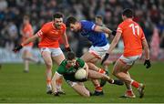 5 February 2023; Conor McStay of Mayo is tackled by Armagh goalkeeper Ethan Rafferty, centre, and team-mates Callum Cumiskey and Rory Grugan during the Allianz Football League Division 1 match between Armagh and Mayo at Box-It Athletic Grounds in Armagh. Photo by Brendan Moran/Sportsfile