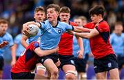7 February 2023; Matthew Haugh of St Michael's College is tackled by Daniel Clarke, left, and Ethan Marshall of CUS during the Bank of Ireland Leinster Rugby Schools Junior Cup First Round match between St Michael’s College and CUS at Energia Park in Dublin. Photo by Ben McShane/Sportsfile