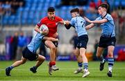 7 February 2023; David Li of CUS is tackled by Eoin Loo, left, and Andrew Norse of St Michael's College during the Bank of Ireland Leinster Rugby Schools Junior Cup First Round match between St Michael’s College and CUS at Energia Park in Dublin. Photo by Ben McShane/Sportsfile