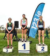 8 February 2023; The Intermediate girls podium, first place Emily Bolton of Mount Sackville Secondary School Chapelizod, centre, second place Eimear Cooney of Sacred Heart Sec. School, right, and third place Leia ryan of Castleknock Community College during the 123.ie Leinster Schools Cross Country 2023 at Santry Demesne in Dublin. Photo by David Fitzgerald/Sportsfile