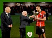 10 February 2023; Derry City captain Will Patching is presented with the President's Cup by President of Ireland Michael D Higgins, and FAI President Gerry McAnaney after the President's Cup match between Derry City and Shamrock Rovers at the Ryan McBride Brandywell Stadium in Derry. Photo by Stephen McCarthy/Sportsfile