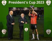 10 February 2023; Derry City captain Will Patching lifts the President's Cup, in the company of President of Ireland Michael D Higgins, centre, and FAI President Gerry McAnaney after the President's Cup match between Derry City and Shamrock Rovers at the Ryan McBride Brandywell Stadium in Derry. Photo by Stephen McCarthy/Sportsfile