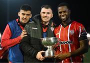 10 February 2023; Derry City players, from left, Cian Kavanagh, Ryan Graydon and Sadou Diallo with the President's Cup after the President's Cup match between Derry City and Shamrock Rovers at the Ryan McBride Brandywell Stadium in Derry. Photo by Stephen McCarthy/Sportsfile