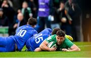 11 February 2023; Hugo Keenan of Ireland scores his side's first try despite the tackle of Thomas Ramos and Romain Ntamack of France during the Guinness Six Nations Rugby Championship match between Ireland and France at the Aviva Stadium in Dublin. Photo by Harry Murphy/Sportsfile