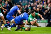 11 February 2023; Hugo Keenan of Ireland scores his side's first try despite the tackle of Thomas Ramos and Romain Ntamack of France during the Guinness Six Nations Rugby Championship match between Ireland and France at the Aviva Stadium in Dublin. Photo by Harry Murphy/Sportsfile