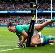 11 February 2023; James Lowe of Ireland scores his side's second try in the 21st minute despite the tackle of Damian Penaud of France during the Guinness Six Nations Rugby Championship match between Ireland and France at the Aviva Stadium in Dublin. Photo by John Dickson/Sportsfile