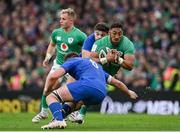 11 February 2023; Bundee Aki of Ireland is tackled by Anthony Jelonch, left, and Romain Ntamack of France, behind, during the Guinness Six Nations Rugby Championship match between Ireland and France at the Aviva Stadium in Dublin. Photo by Seb Daly/Sportsfile