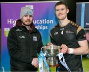 15 February 2023; TUS Mdlands captain Shane Allen is presented with the cup by Higher Education GAA chairperson Mike Hyland after the Electric Ireland HE Trench Cup Final match between Dundalk Institute of Technology and Technological University of the Shannon Midlands at SETU West Campus in Waterford. Photo by Brendan Moran/Sportsfile