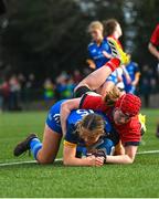 16 February 2023; Robyn O'Connor of Leinster dives over to score her side's third try despite the tackle of Beth Buttimer of Munster during the U18 Girls Interprovincial match between Leinster and Munster at Terenure College in Dublin. Photo by Harry Murphy/Sportsfile