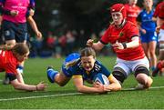 16 February 2023; Robyn O'Connor of Leinster dives over to score her side's third try despite the tackle of Fia Whelan, left, and Beth Buttimer of Munster during the U18 Girls Interprovincial match between Leinster and Munster at Terenure College in Dublin. Photo by Harry Murphy/Sportsfile
