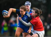 16 February 2023; Emma-Jane Wilson of Leinster offloads despite the tackle of Grainne Burke of Munster during the U18 Girls Interprovincial match between Leinster and Munster at Terenure College in Dublin. Photo by Harry Murphy/Sportsfile