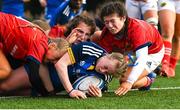 16 February 2023; Caoimhe McCormack of Leinster scores her side's fourth try despite the tackle of Munster players, from left, Rebecca Rogers, Clodagh O'Keeffe and Emma Dunican during the U18 Girls Interprovincial match between Leinster and Munster at Terenure College in Dublin. Photo by Harry Murphy/Sportsfile