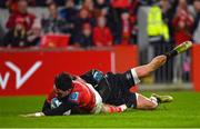 17 February 2023; Joey Carbery of Munster scores his side's fourth try despite the tackle of Luke Morgan of Ospreys during the United Rugby Championship match between Munster and Ospreys at Thomond Park in Limerick. Photo by Harry Murphy/Sportsfile