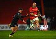 17 February 2023; Simon Zebo of Munster kicks under pressure from Luke Morgan of Ospreys during the United Rugby Championship match between Munster and Ospreys at Thomond Park in Limerick. Photo by Harry Murphy/Sportsfile
