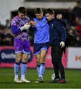 17 February 2023; Adam Wells of UCD, centre, is assisted off after picking up an injury during the SSE Airtricity Men's Premier Division match between Dundalk and UCD at Oriel Park in Dundalk, Louth. Photo by Ben McShane/Sportsfile