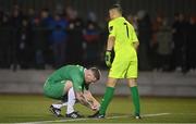 17 February 2023; Kalen Spillane of Kerry FC ties the lace of teammate Wayne Guthrie during the SSE Airtricity Men's First Division match between Kerry and Cobh Ramblers at Mounthawk Park in Tralee, Kerry. Photo by Brendan Moran/Sportsfile