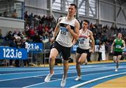 18 February 2023; Jack Raftery of Donore Harriers AC, Dublin, winks on the way to winning his senior men's 400m heat during day one of the 123.ie National Senior Indoor Championships at National Indoor Arena in Dublin. Photo by Sam Barnes/Sportsfile