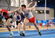 18 February 2023; Matthew Behan of Crusaders AC, Dublin, dips for the line to win the senior men's 60m Hurdles during day one of the 123.ie National Senior Indoor Championships at National Indoor Arena in Dublin. Photo by Sam Barnes/Sportsfile
