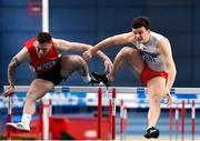 18 February 2023; Matthew Behan of Crusaders AC, Dublin, right, on his way to winning the senior men's 60m Hurdles ahead  of Josh Armstrong of City of Lisburn AC, Down, during day one of the 123.ie National Senior Indoor Championships at National Indoor Arena in Dublin. Photo by Sam Barnes/Sportsfile
