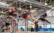 18 February 2023; Matthew Behan of Crusaders AC, Dublin, centre, on his way to winning the senior men's 60m Hurdles ahead of Josh Armstrong of City of Lisburn AC, Down, left, and Valantinos Goularas of Crusaders AC, Dublin, right, during day one of the 123.ie National Senior Indoor Championships at National Indoor Arena in Dublin. Photo by Sam Barnes/Sportsfile