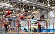 18 February 2023; Matthew Behan of Crusaders AC, Dublin, centre, on his way to winning the senior men's 60m Hurdles ahead of Josh Armstrong of City of Lisburn AC, Down, left, and Valantinos Goularas of Crusaders AC, Dublin, right, during day one of the 123.ie National Senior Indoor Championships at National Indoor Arena in Dublin. Photo by Sam Barnes/Sportsfile