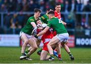 18 February 2023; Niall Loughlin of Derry is tackled by Adam O'Neill, left, and Harry O'Higgins of Meath during the Allianz Football League Division Two match between Derry and Meath at Derry GAA Centre of Excellence in Owenbeg, Derry. Photo by Ben McShane/Sportsfile