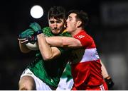 18 February 2023; Diarmuid Moriarty of Meath is tackled by Padraig McGrogan of Derry during the Allianz Football League Division Two match between Derry and Meath at Derry GAA Centre of Excellence in Owenbeg, Derry. Photo by Ben McShane/Sportsfile