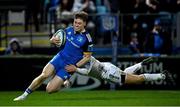 18 February 2023; Rob Russell of Leinster on his way to scoring his side's sixth try despite the tackle of Will Reed of Dragons during the United Rugby Championship match between Leinster and Dragons at RDS Arena in Dublin. Photo by Harry Murphy/Sportsfile