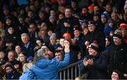 19 February 2023; Supporters applaud Uachtarán Tofa Chumann Lúthchleas Gael Jarlath Burns as he takes to his seat before the Allianz Football League Division One match between Roscommon and Armagh at Dr Hyde Park in Roscommon. Photo by Harry Murphy/Sportsfile