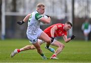 19 February 2023; Adrian Enright of Limerick evades the tackle of Conal McKeever of Louth during the Allianz Football League Division Two match between Louth and Limerick at Páirc Mhuire in Ardee, Louth. Photo by Ben McShane/Sportsfile