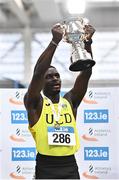 19 February 2023; Israel Olatunde of UCD AC, Dublin, lifts the Craig Lynch Memorial Trophy after winning the senior men's 60m final during day two of the 123.ie National Senior Indoor Championships at National Indoor Arena in Dublin. Photo by Sam Barnes/Sportsfile