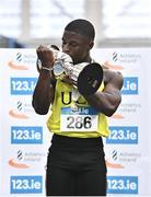 19 February 2023; Israel Olatunde of UCD AC, Dublin, kisses the Craig Lynch Memorial Trophy after winning the senior men's 60m final during day two of the 123.ie National Senior Indoor Championships at National Indoor Arena in Dublin. Photo by Sam Barnes/Sportsfile